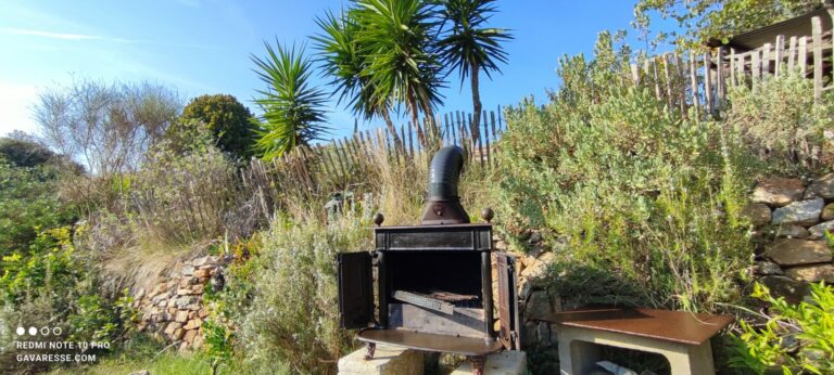 Ancien poêle à bois en fonte transformé en barbecue dans le jardin méditerranéen en restanques du Mas de la Gavaresse au Pradet.