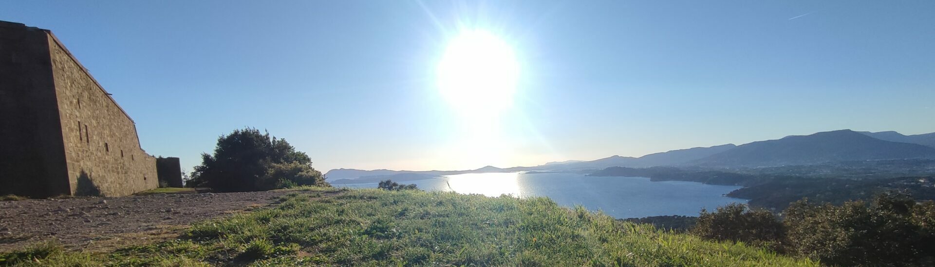 Panoramic view from Fort de la Gavaresse in Le Pradet overlooking the Toulon bay, Mount Faron, Mount Coudon, and the Bec de l'Aigle cliffs in the distance.