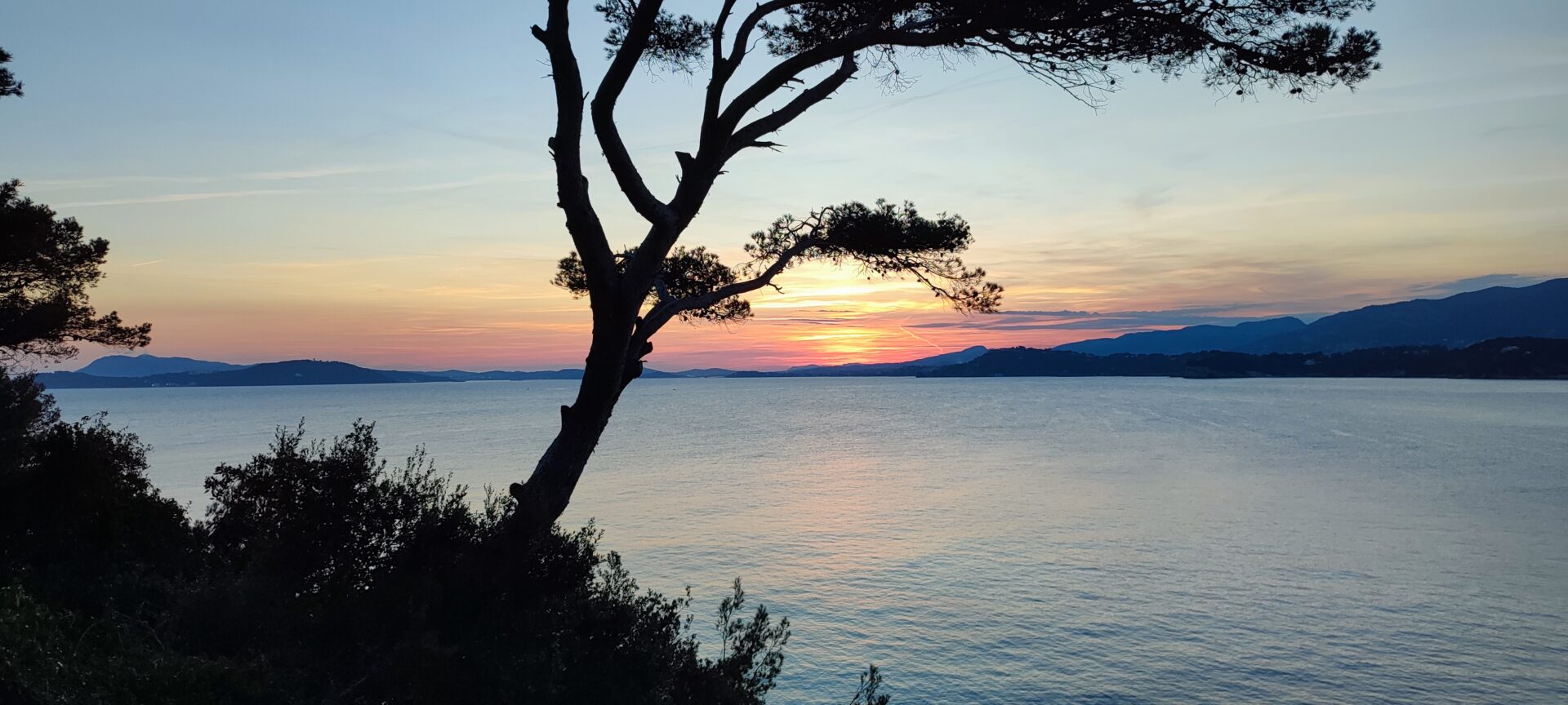 Sunset over the Toulon bay and Saint-Mandrier peninsula seen from the coastal path below Mas de la Gavaresse in Le Pradet, Var.